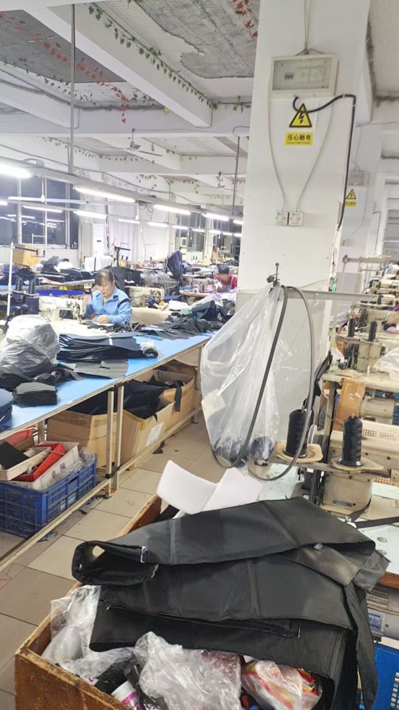 Workers sewing bag panels